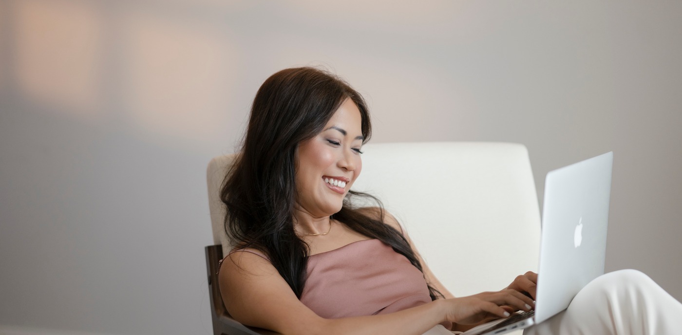Nina Hoang working from a laptop, smiling